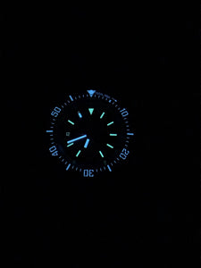 SWCS watch glowing with BGW9 lume in darkness